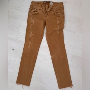 Brown Jeans With Small Rips; the rips don’t show any skin